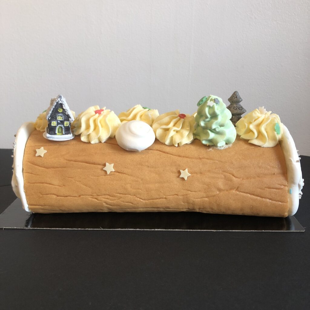 Nous ajoutons des petites meringue à notre bûche Praliné / Passion.